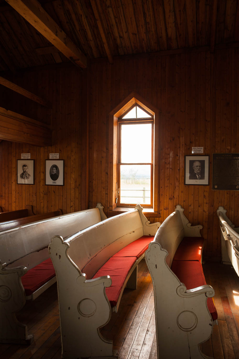 Photograph of the interior of the McDougall United Memorial Church depicting pews and wood panelling.