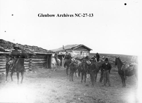 Cowboys at Perrenoud's ranch log cabin, Cochrane, Alberta.