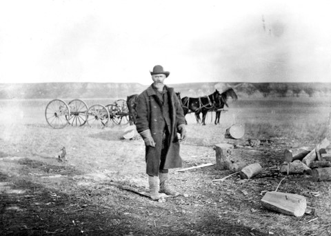 John Glenn stood in front of horse and cart was the first documented European to settle in the Calgary, Alberta area. Date between 1873-1886.