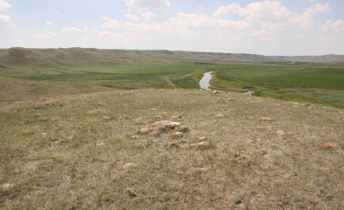 A stone cairn at archaeological site EaPd-8 with the Prairie landscape in the background.