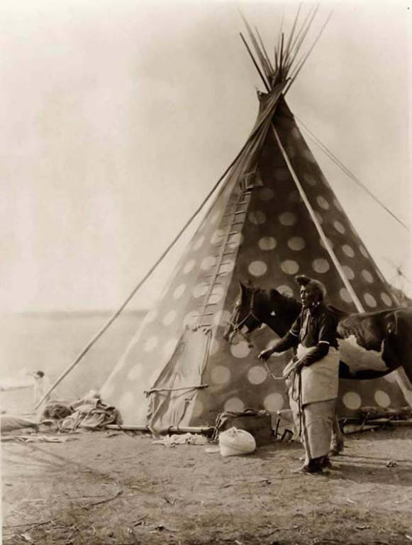 Bear Bull, holding a horse outside his tipi, taken by Edward S. Curtis 1927.