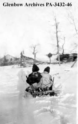 Irene and Ruth Olsen on a sled, Bar U Ranch, Pekisko, Alberta, 1921-1922.