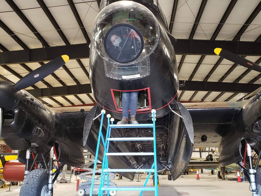 Image showing the set up of the Leica BLK360 laser scanner inside the nose of the plane, set up on a ladder to capture the front turret.