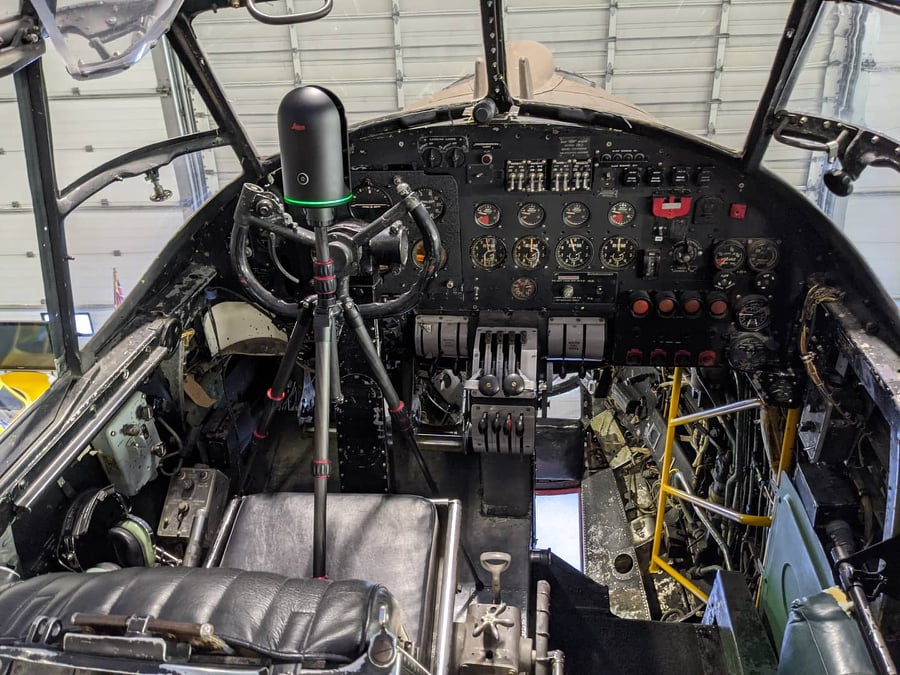 Image showing the Leica BLK360 terrestrial laser scanner set up on the pilot's seat of the plane to capture the interior of the cockpit.