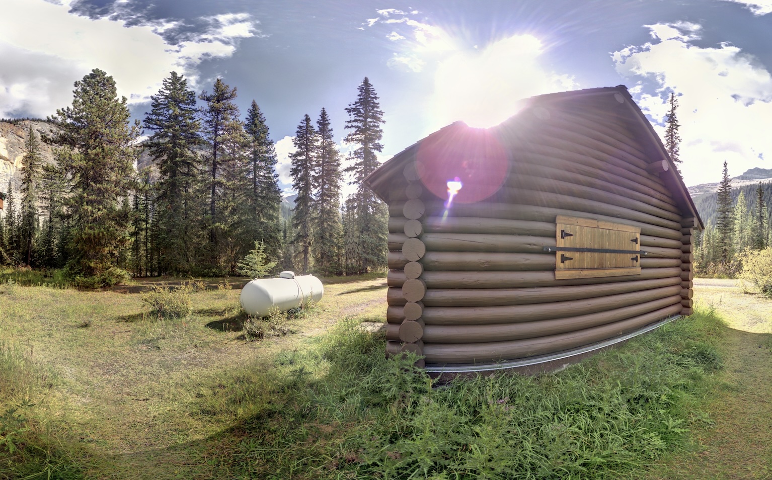 The Takakkaw Falls Warden's Patrol Cabin during digital documentation with Z+F 5010X scanner. Takakkaw Falls are visible through the trees on the right side of the photo. Photo from Capture2Preserv project.